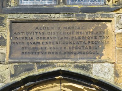 Latin plaque above St Mary's south door