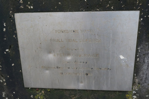 A plaque to the 1986 tidal defence wall. Paull
