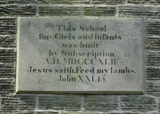 Plaque on the old girls and infants school in Woolley